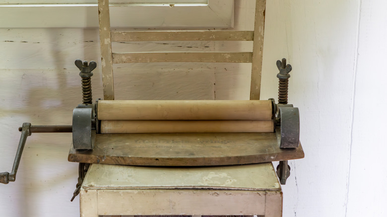 An antique clothes wringer on a table