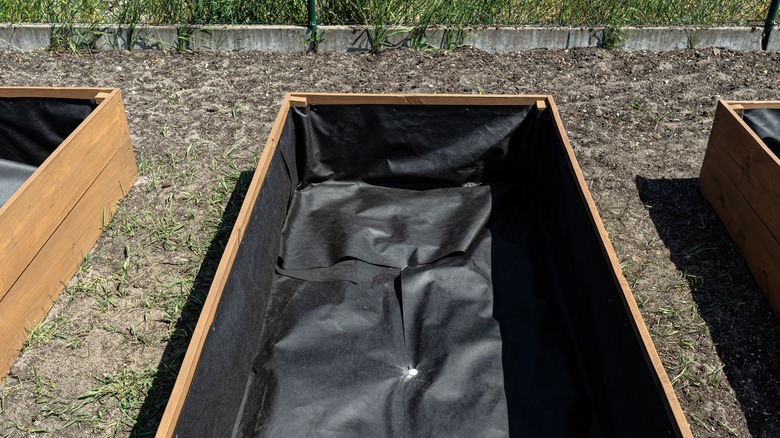 Raised bed with black landscape fabric ready for soil