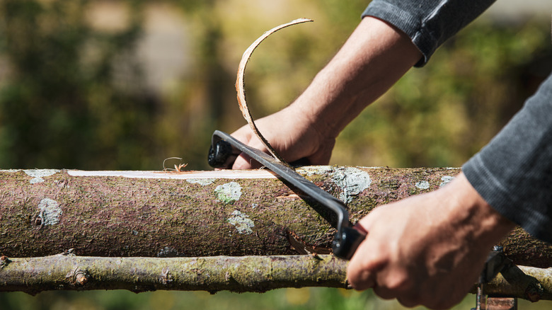 Man using drawnknife