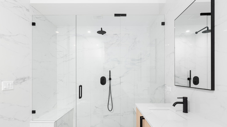 White bathroom with black fixtures and hardware