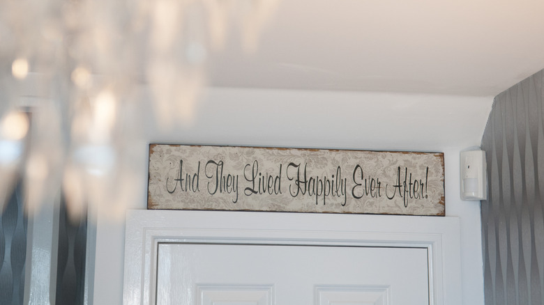 Sign over a door with phrase "and they lived happily ever after"