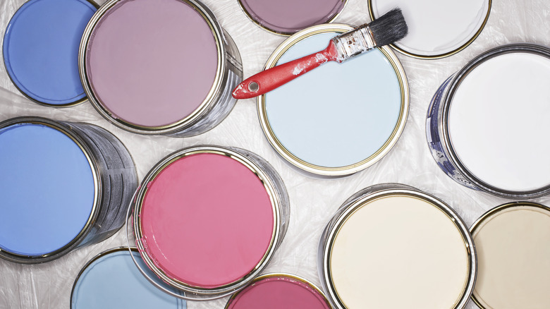 colorful paint cans with brush