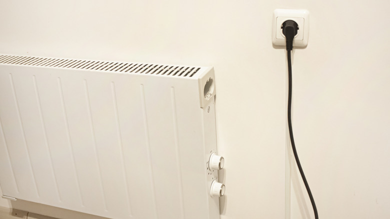 An electric heater on a wall with just a plug required to power it