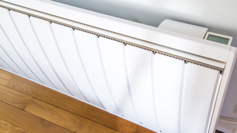 An angled close-up of an electric radiator on a wall