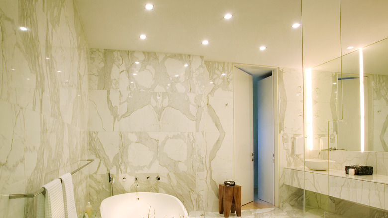 Tiled bathroom with lots of shine reflecting off the tile
