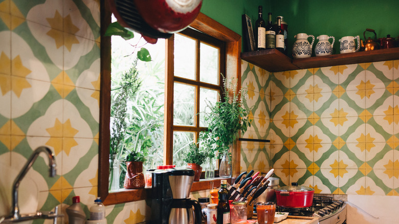 Kitchen with patterned yellow and green tiles on the wall