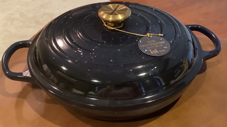 A Le Creuser brasier dish decorated with a pattern called Cosmos, which is dark blue and studded with constellations