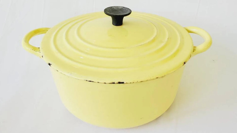 A vintage Le Creuset Dutch oven in a bright hue known as Elysee Yellow