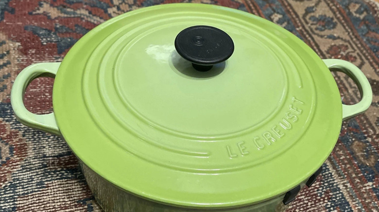 A bright, light green Le Creuset Dutch oven in the rare Kiwi color