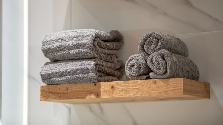 Towels stored on a bathroom shelf
