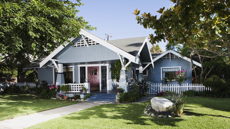 A traditional craftsman home and front yard.