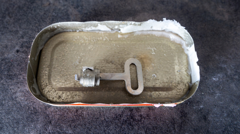 The lid of a vintage tin can and a key opener.