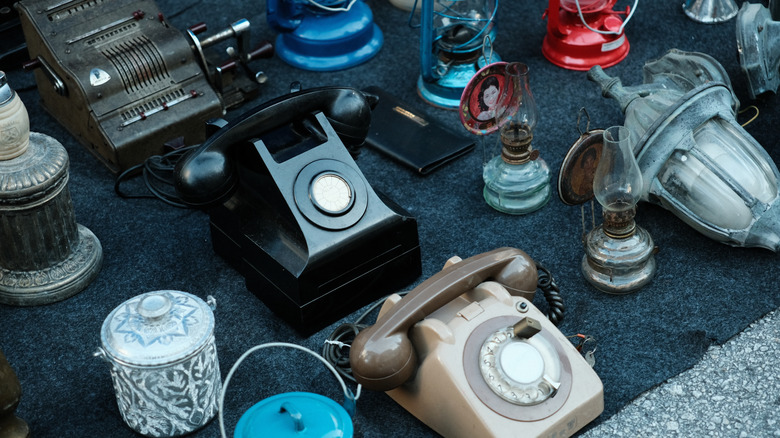 An array of vintage items like telephones and lanterns.
