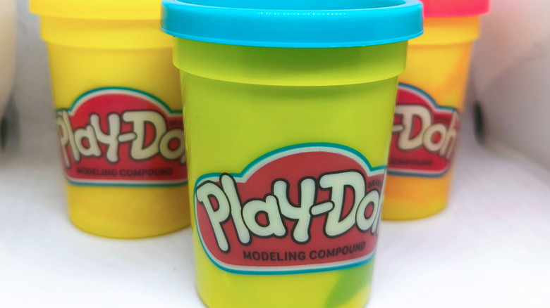Three small buckets of Play-Doh.