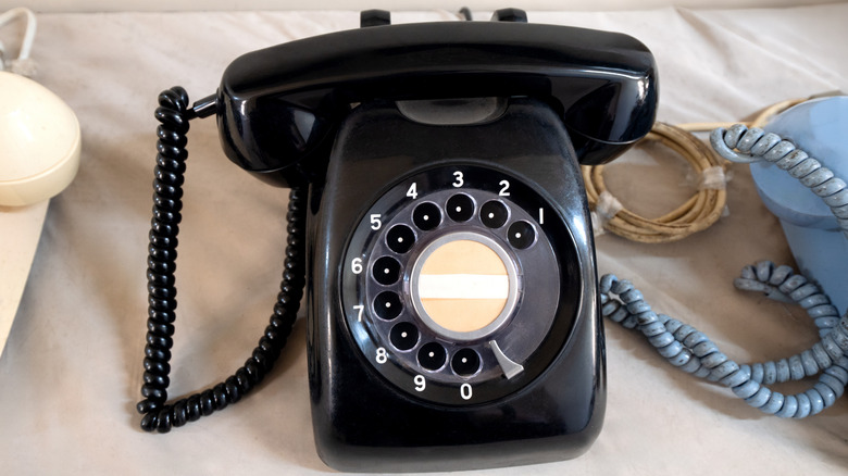 A close-up on a black rotary phone.