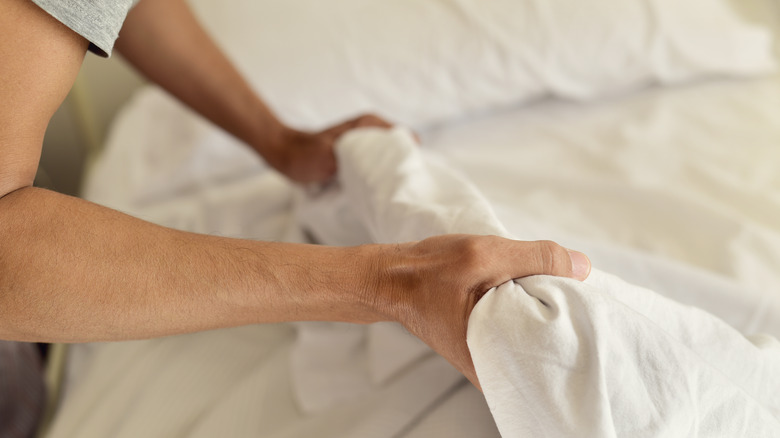 Person making the bed