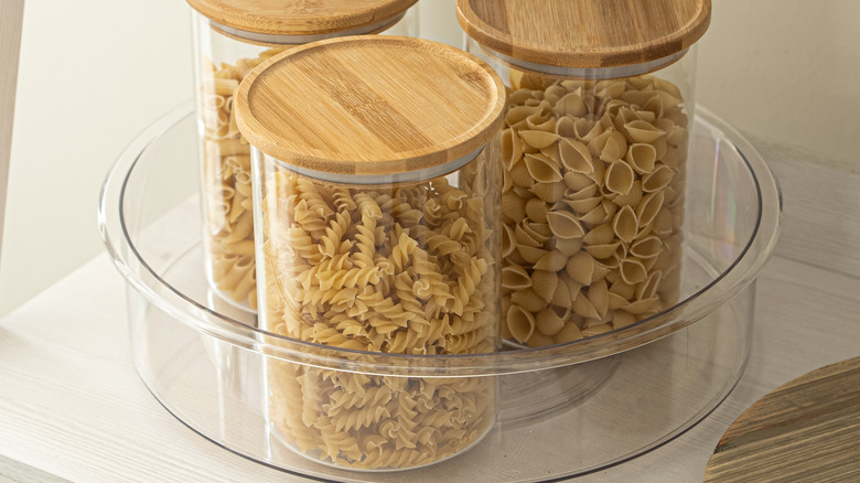 A Lazy Susan holding jars of dried pasta
