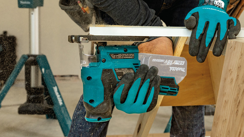 A person performing an undercut in wood with Makita's 18V LXT Lithium-Ion Brushless Cordless Barrel Grip Jig Saw
