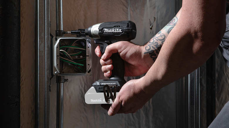 A person driving screws into metal with Makita's 18V LXT Sub-Compact Lithium-Ion Brushless Cordless Impact Driver