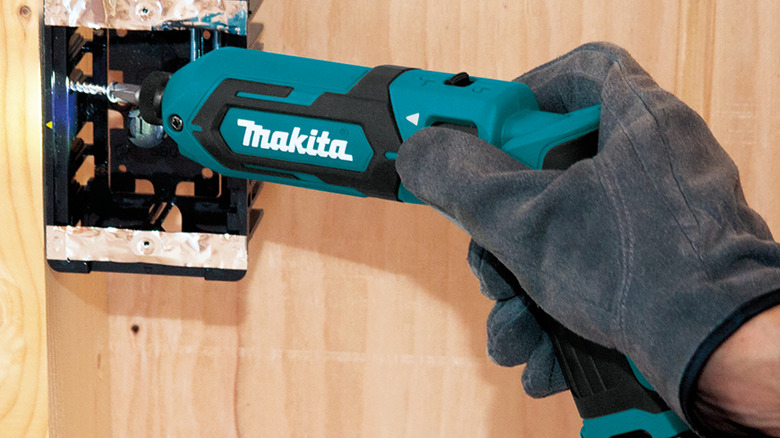 Close-up of a person driving fasteners into a wall outlet with Makita's 7.2V Lithium-Ion Cordless ¼-inch Hex Impact Driver