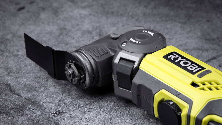 A Ryobi oscillating cutting tool on a dark countertop