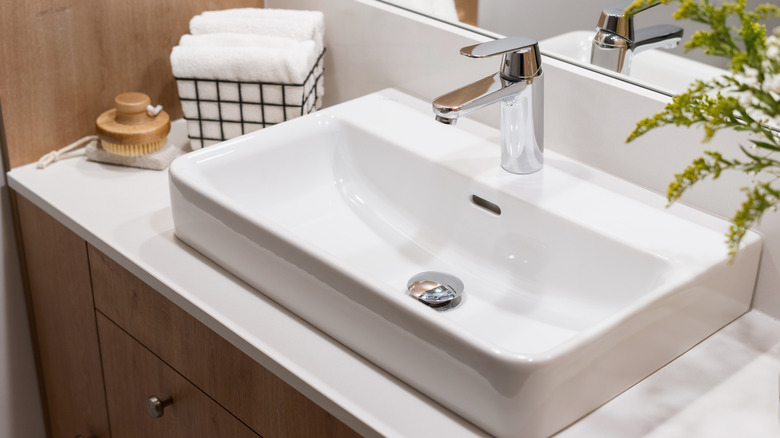 An angled shot of a pristine white ceramic bathroom sink