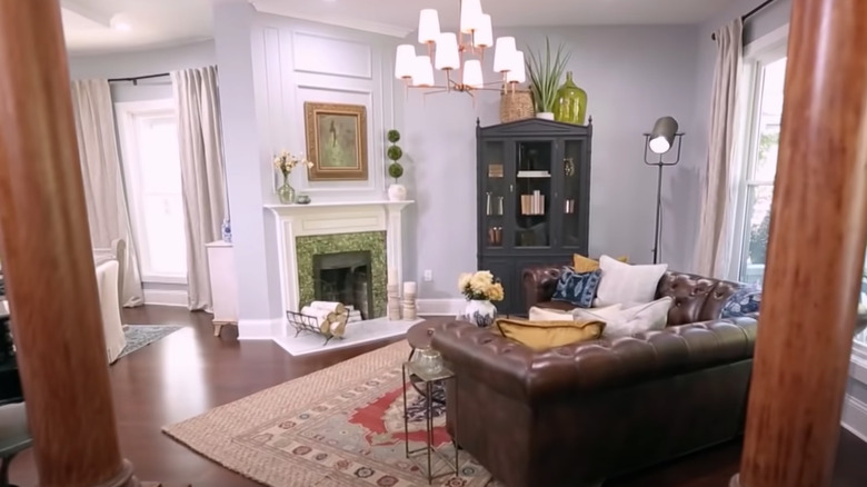 furniture facing green tiled fireplace