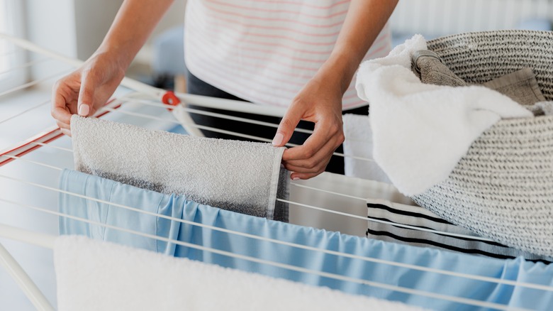 Person air drying laundry