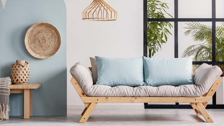 Wooden futon with blue pillows