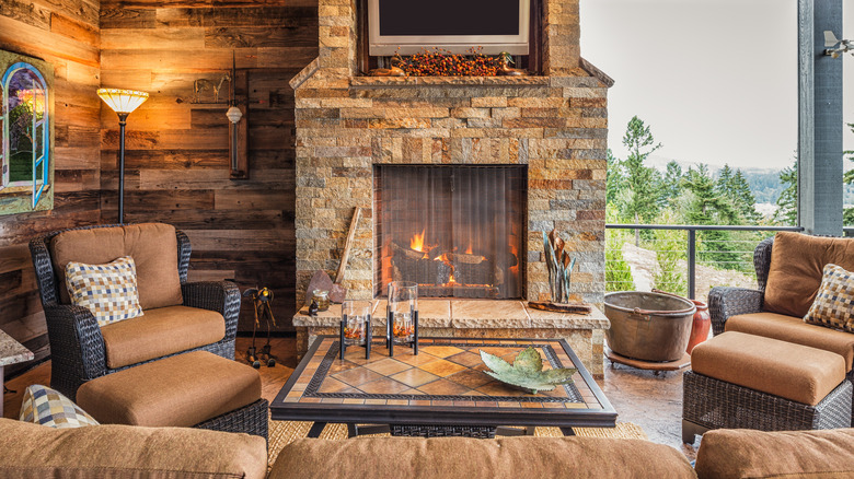 chairs around a stone fireplace