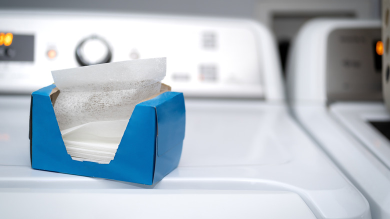 A stack of dryer sheets on top of a washing machine.