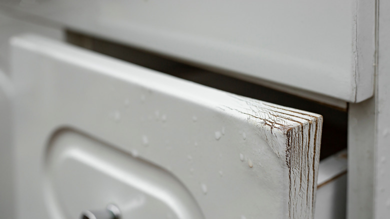 Kitchen drawer with chipped white paint