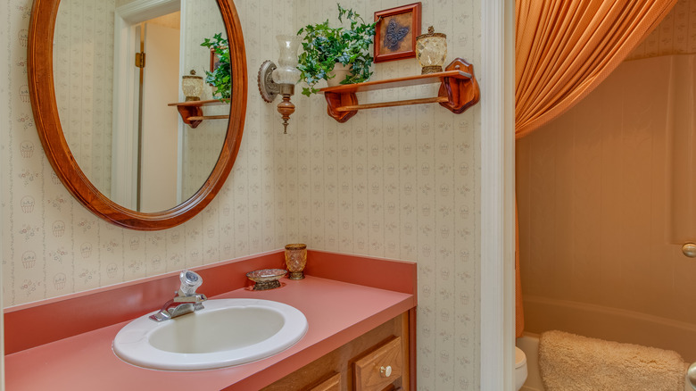 outdated bathroom with wallpaper