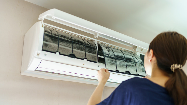 A woman cleaning air filters