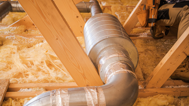 Ductwork being installed in the attic of a house