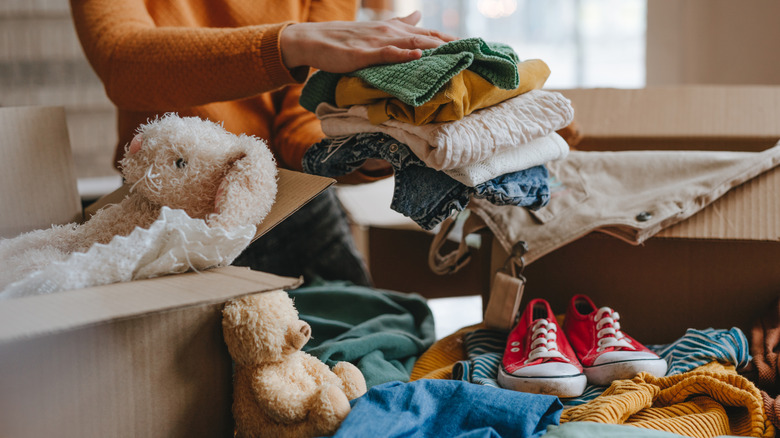 Woman sorting clothes and toys for donation