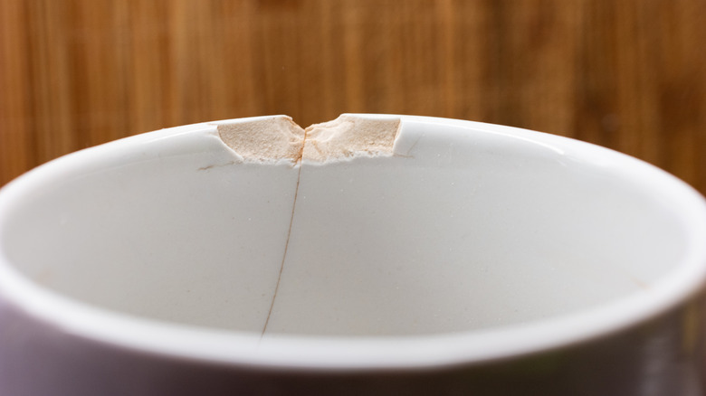 Close-up of a chipped and cracked white dish