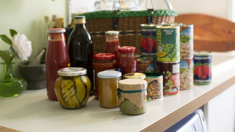 Canned and jarred goods sitting on a white countertop