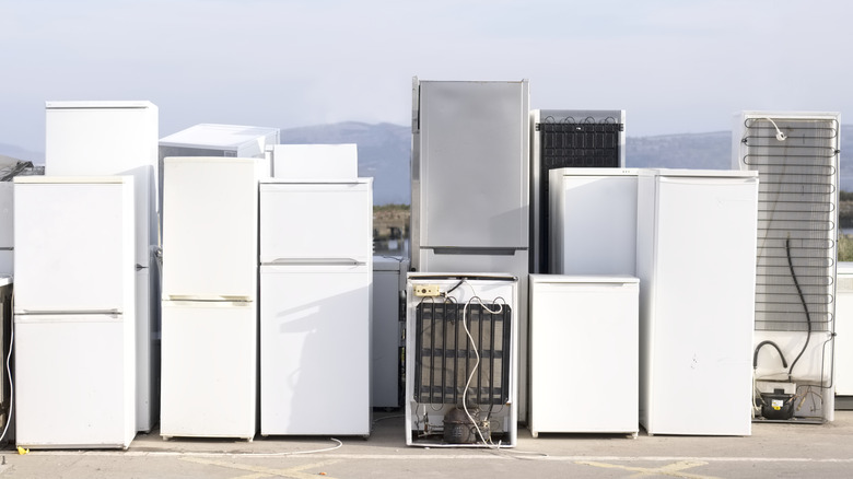 Several fridges sitting outside