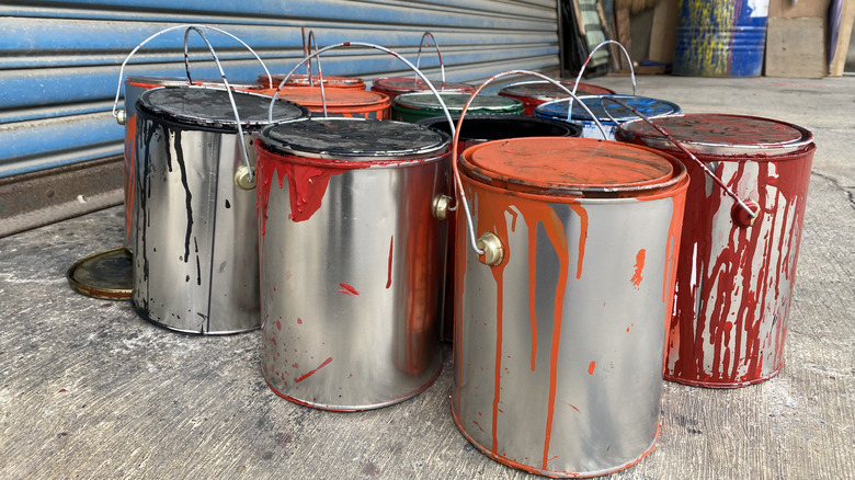 Leftover paint cans sitting in a garage