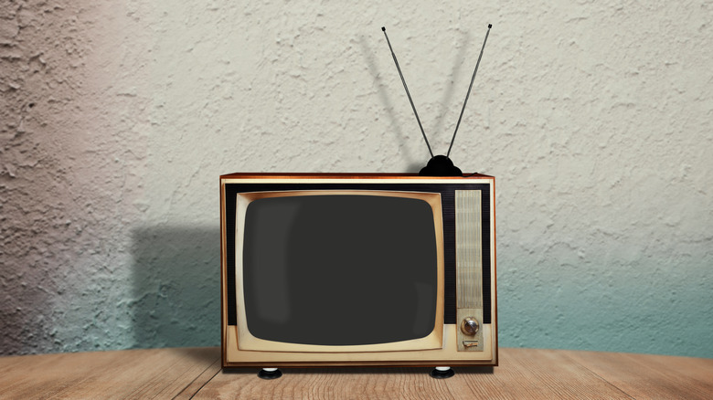 Close-up of a vintage TV sitting on a wooden surface