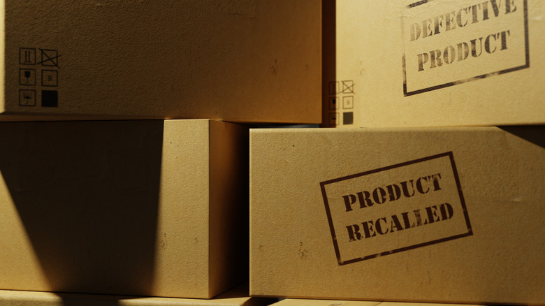 Cardboard boxes labeled defective product and product recalled