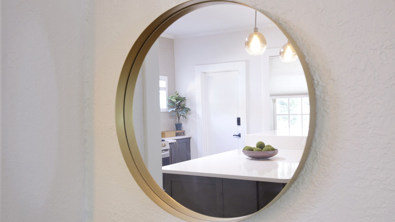 Round mirror with a kitchen reflection