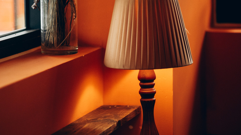 Small table lamp next to a windowsill