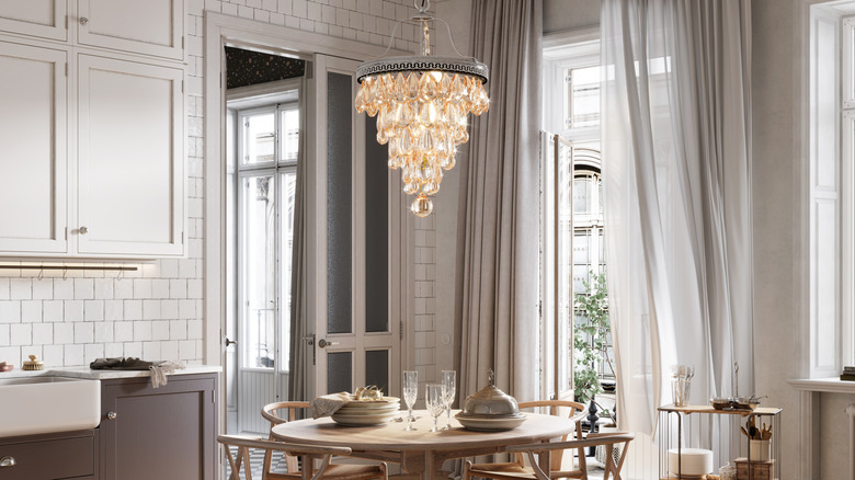 Chandelier hanging over a kitchen table