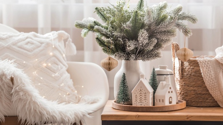 A closeup of a cozy nook with white vase and white building decor