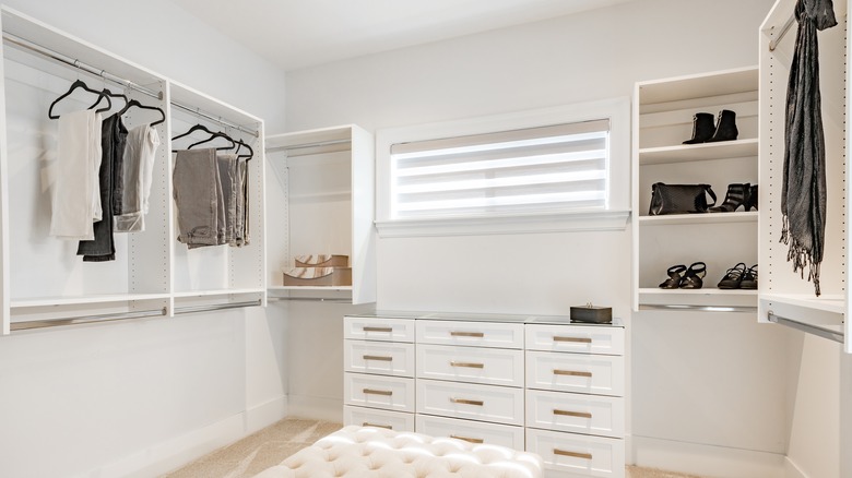 clothes hanging in white closet