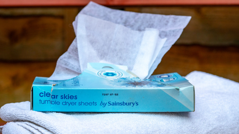 A box of dryer sheets sits on top of a folded towel