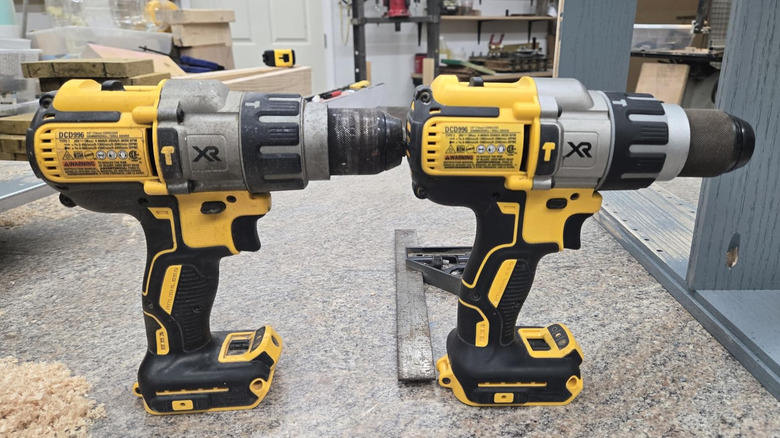 Side-by-side of new and old DeWalt hammer drills on stone surface in workshop