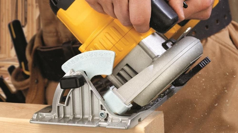 Close-up of DeWalt circular saw on wood plank